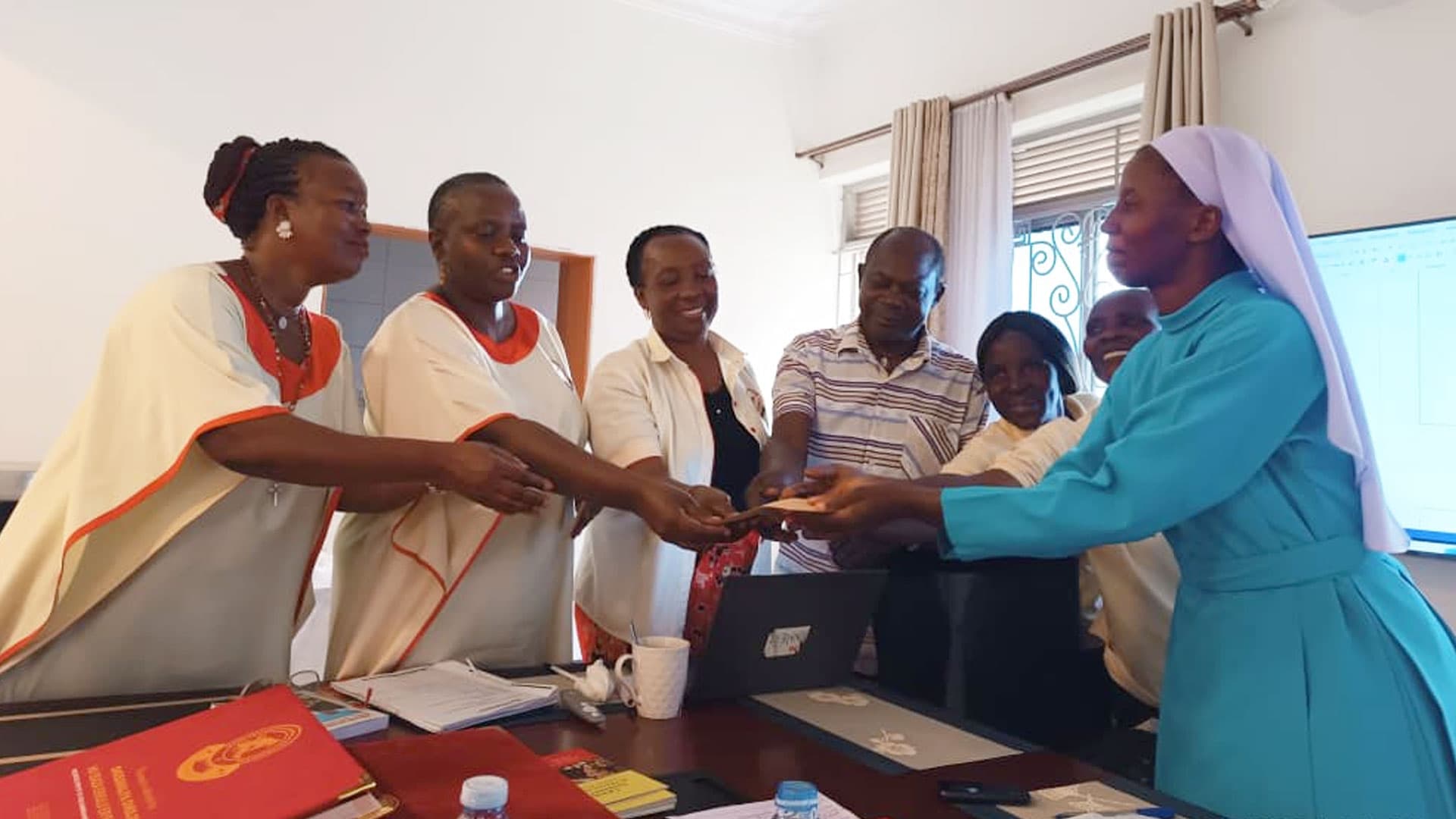 Chaconet partner representatives attending a coordination meeting at Caritas Kampala