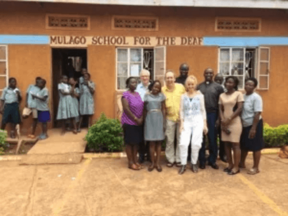 Pupils, staff and visitors outside the entrance of Mulago School for the Deaf